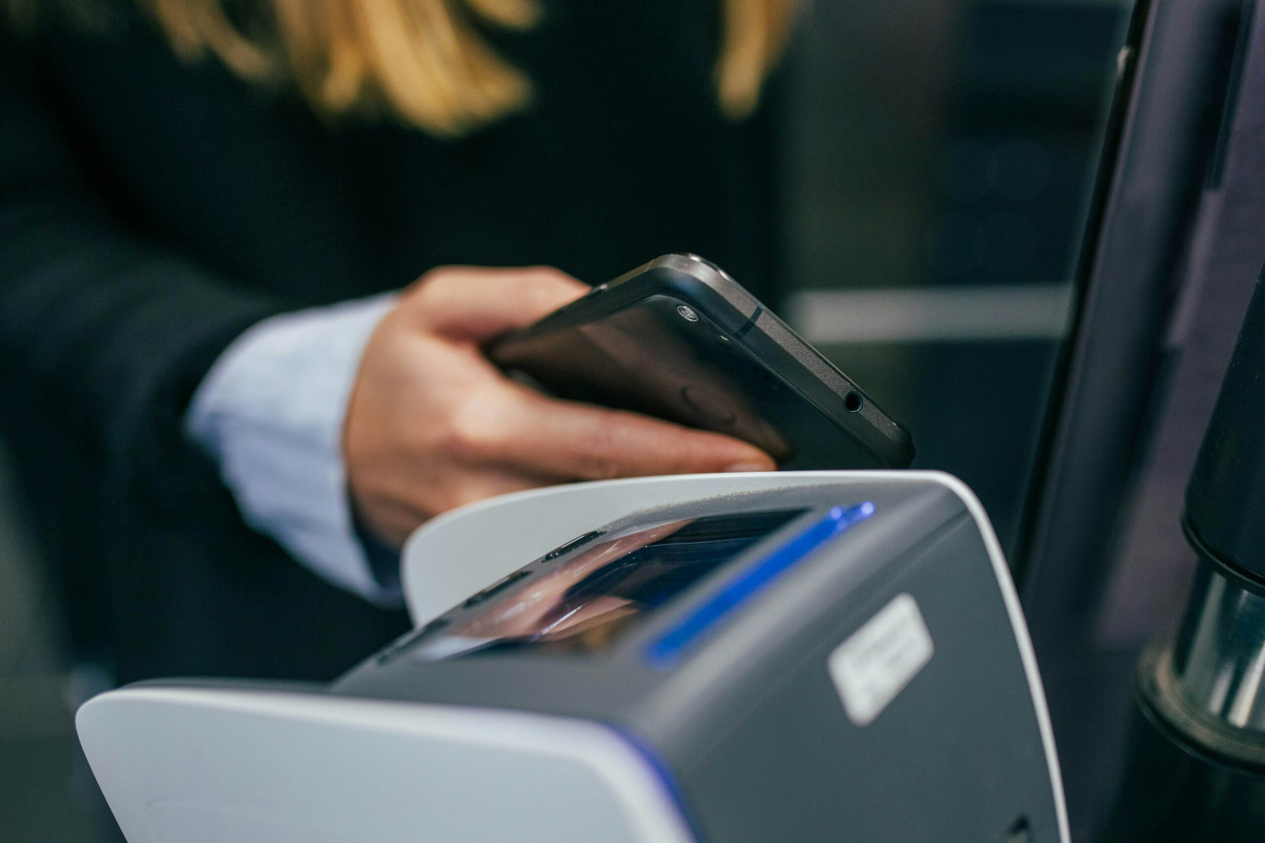Woman paying for goods with smart phone