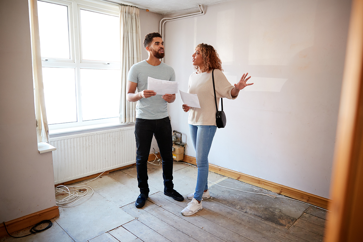 photo of young couple viewing a house.