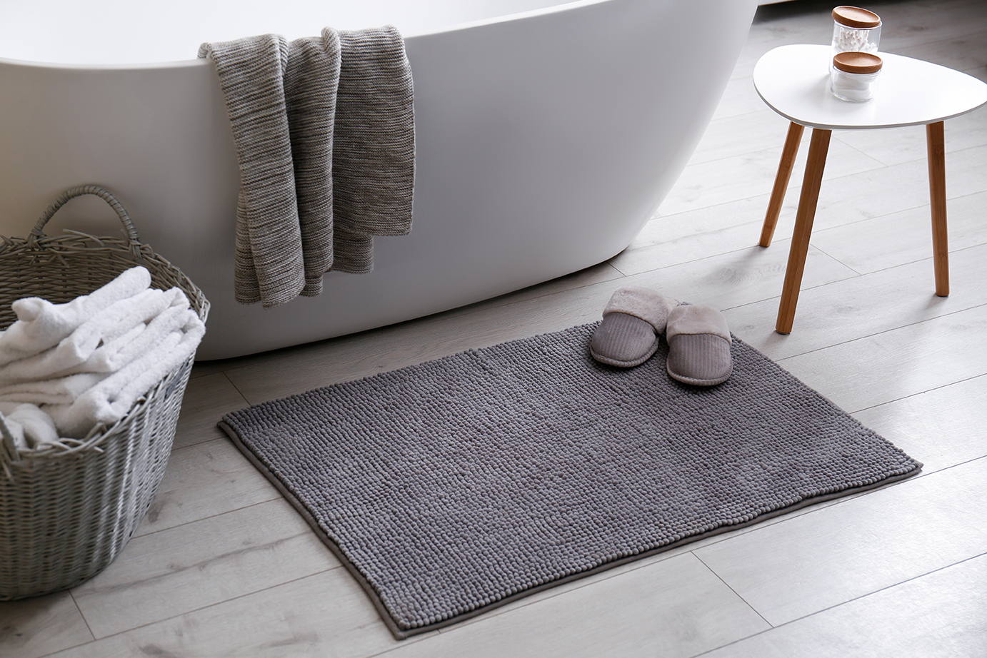 photo of bath with bath mat and towels